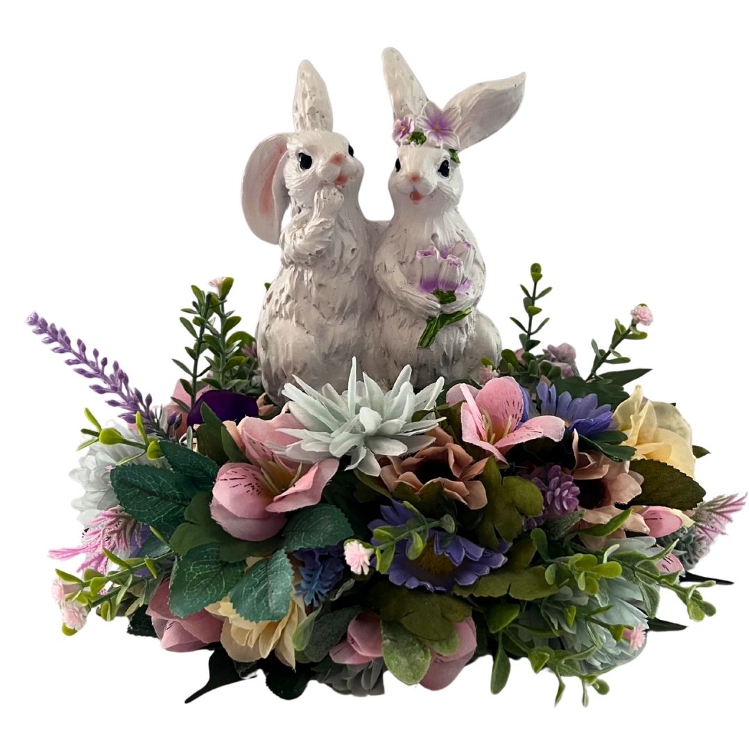 One of a kind lighted Easter bunny centerpiece with resin bunnies, pastel flowers, greenery, and carrot-shaped fairy lights
