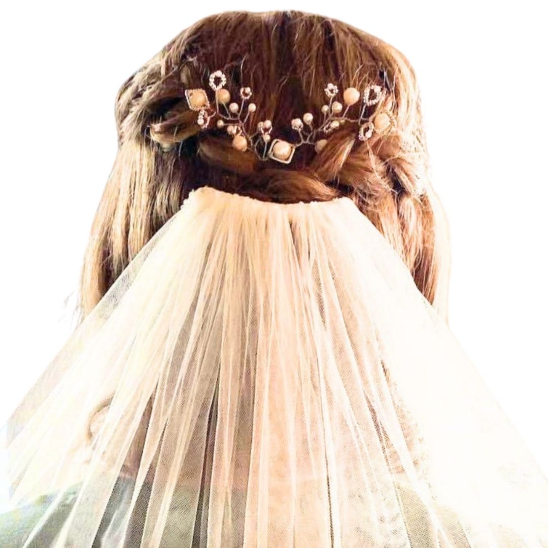 Close up of bridal hair vine with blush pearls and geometric metal shapes woven into blonde hair