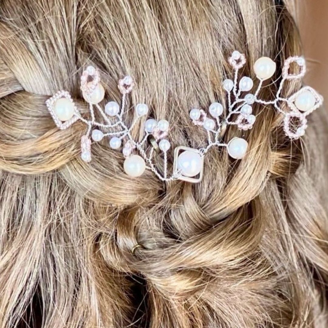 Close up of bridal hair vine with blush pearls and geometric metal shapes woven into blonde hair