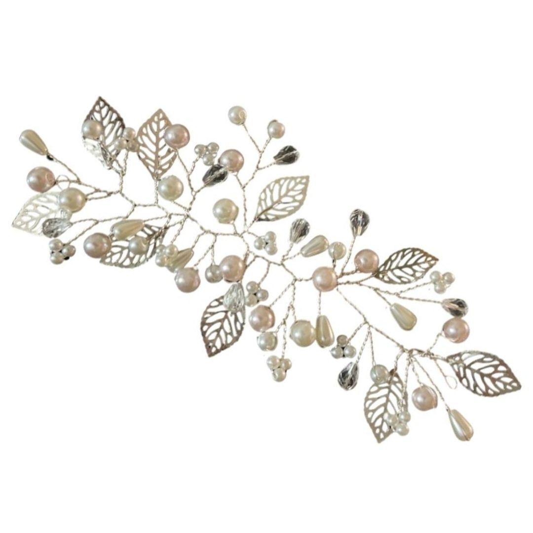 Close up of pearl and crystal bridal hair vine with silver metal leaves detail