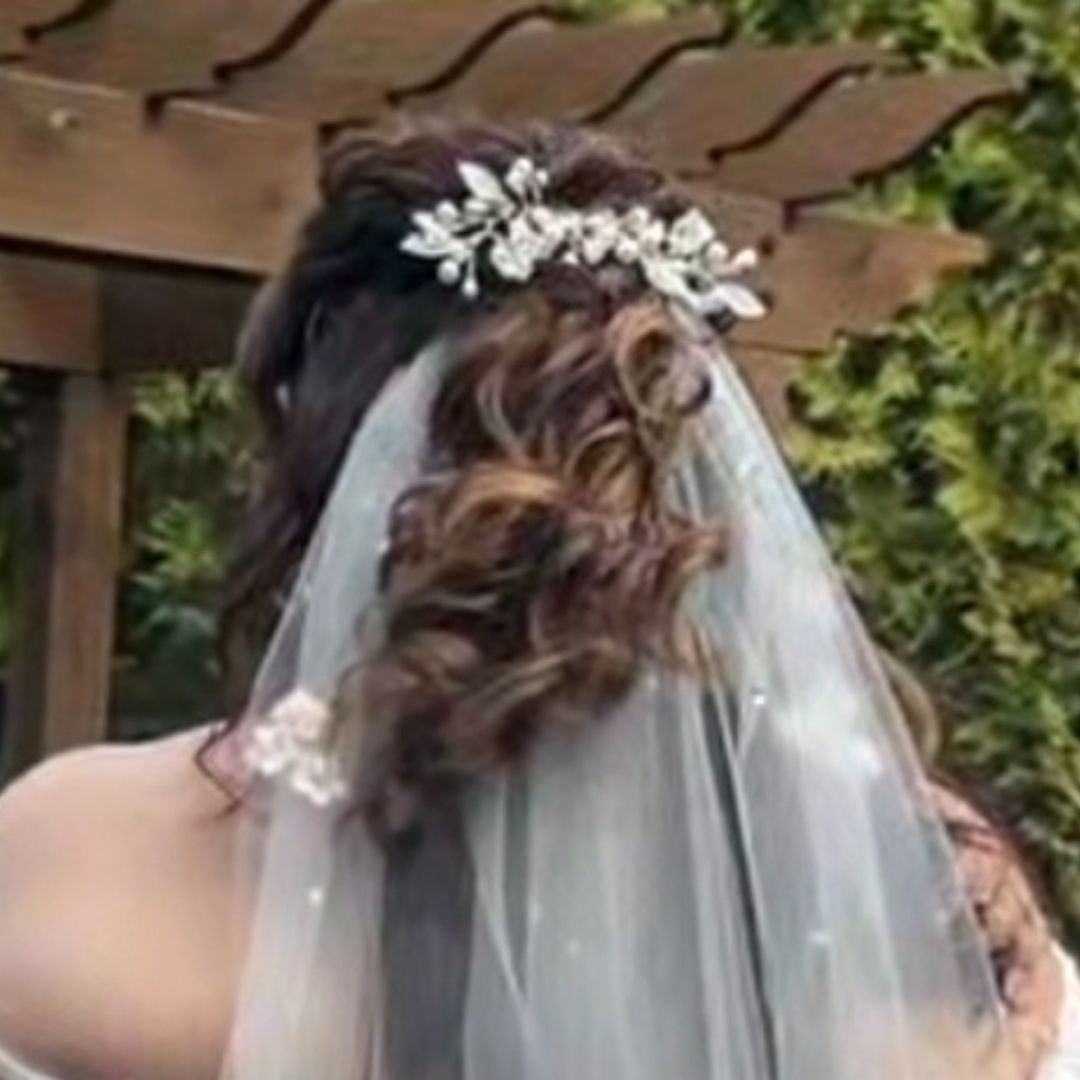 Back view of bridal hairstyle with pearl and crystal hair vine styled with veil