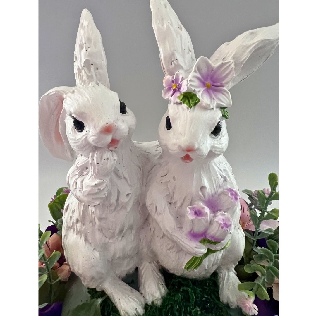 Close up of resin bunny couple in spring Easter centerpiece