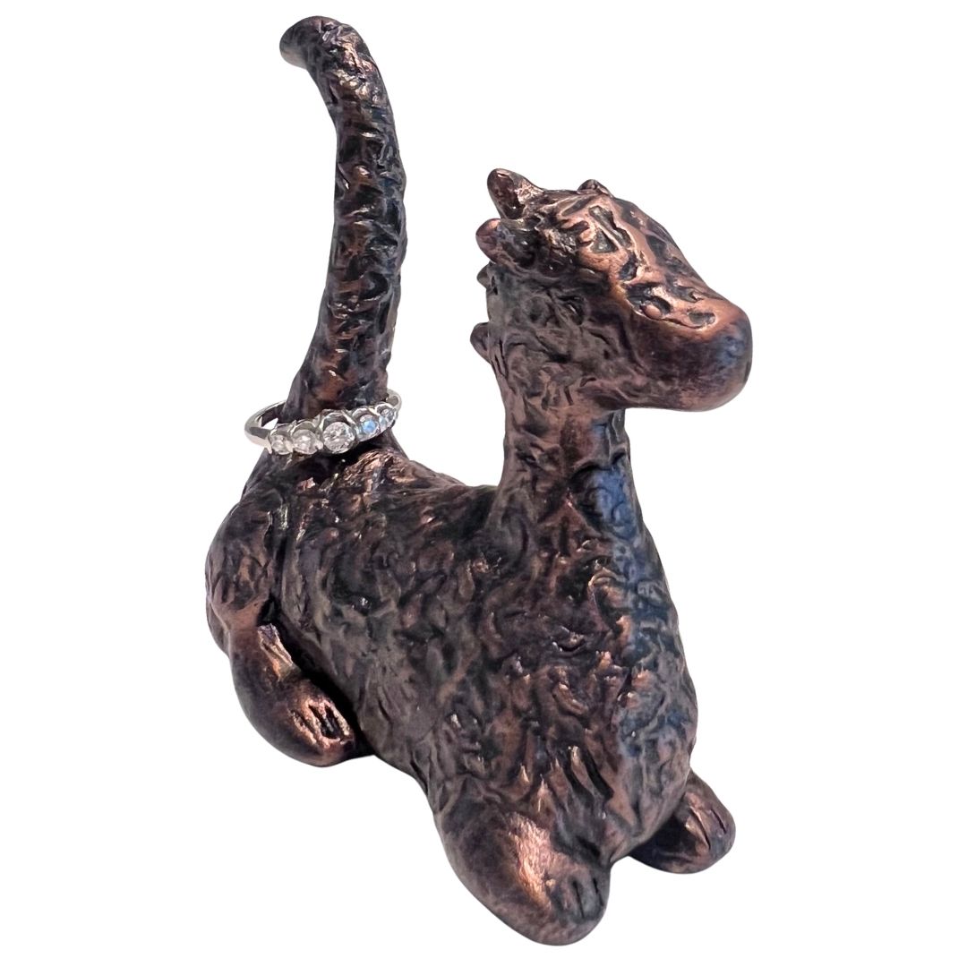 Hand sculpted bronze toned dragon ring holder with textured details and ring displayed on the tail