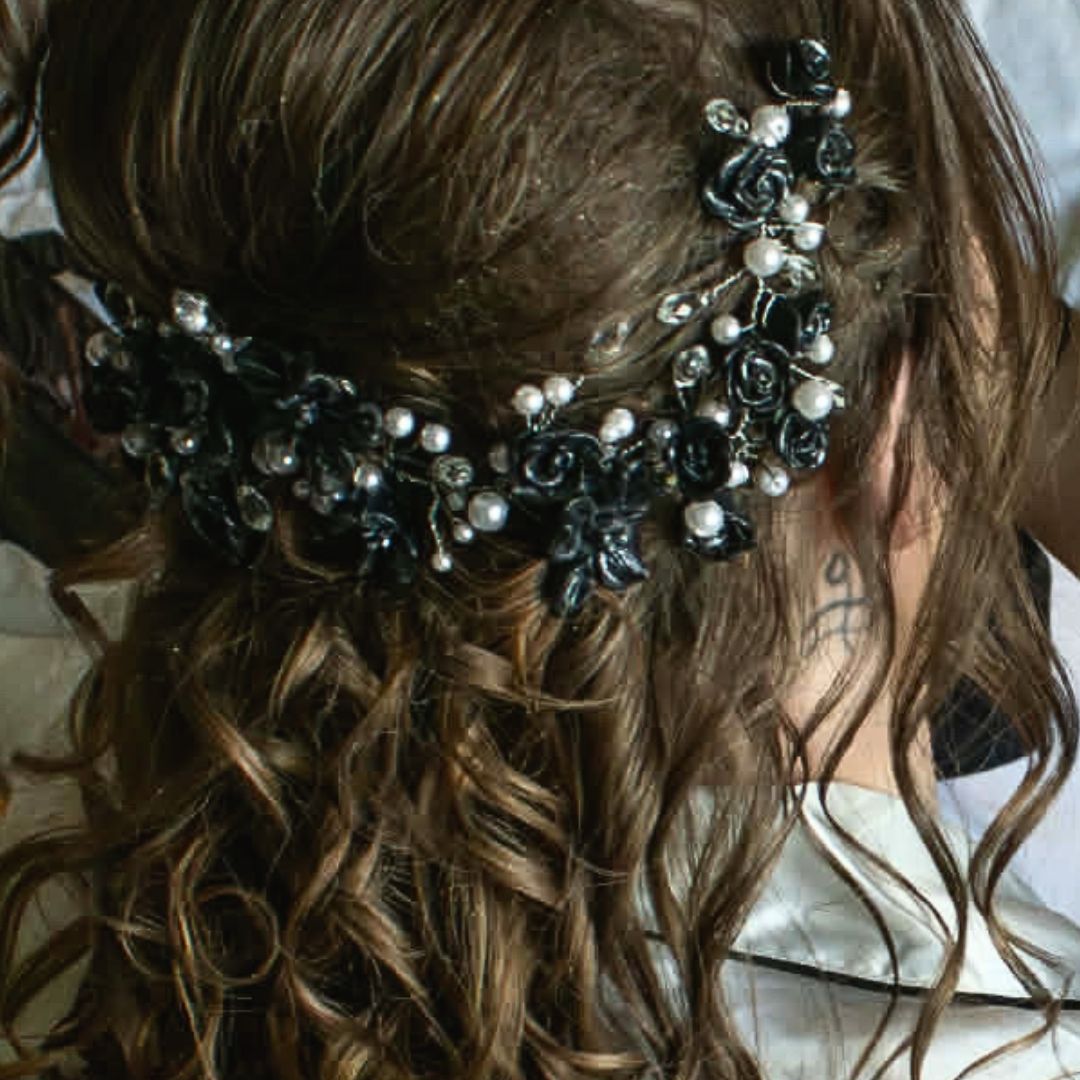 Gothic bridal hair accessories worn in half up hairstyle with black polymer clay flowers, white pearls, and teardrop crystals