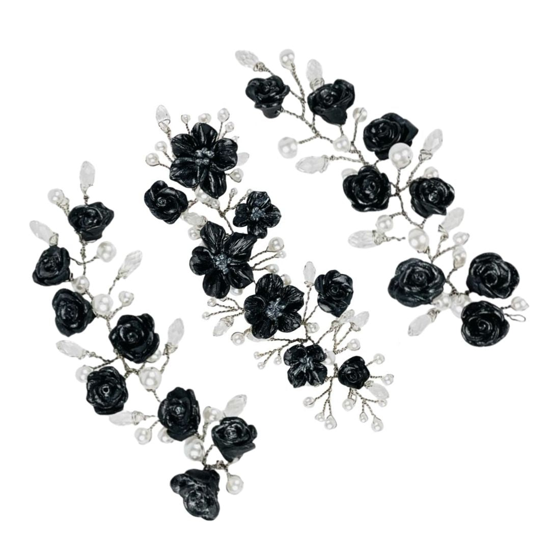 Close-up of hand sculpted black polymer clay flowers with pearl and teardrop crystal accents in gothic hair accessory set