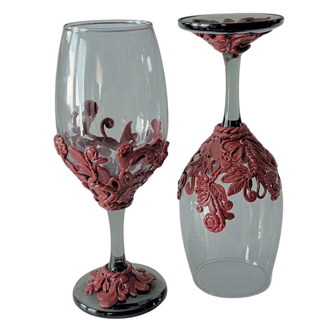 Front and underside view of hand sculpted burgundy wine glasses showing sculpted details