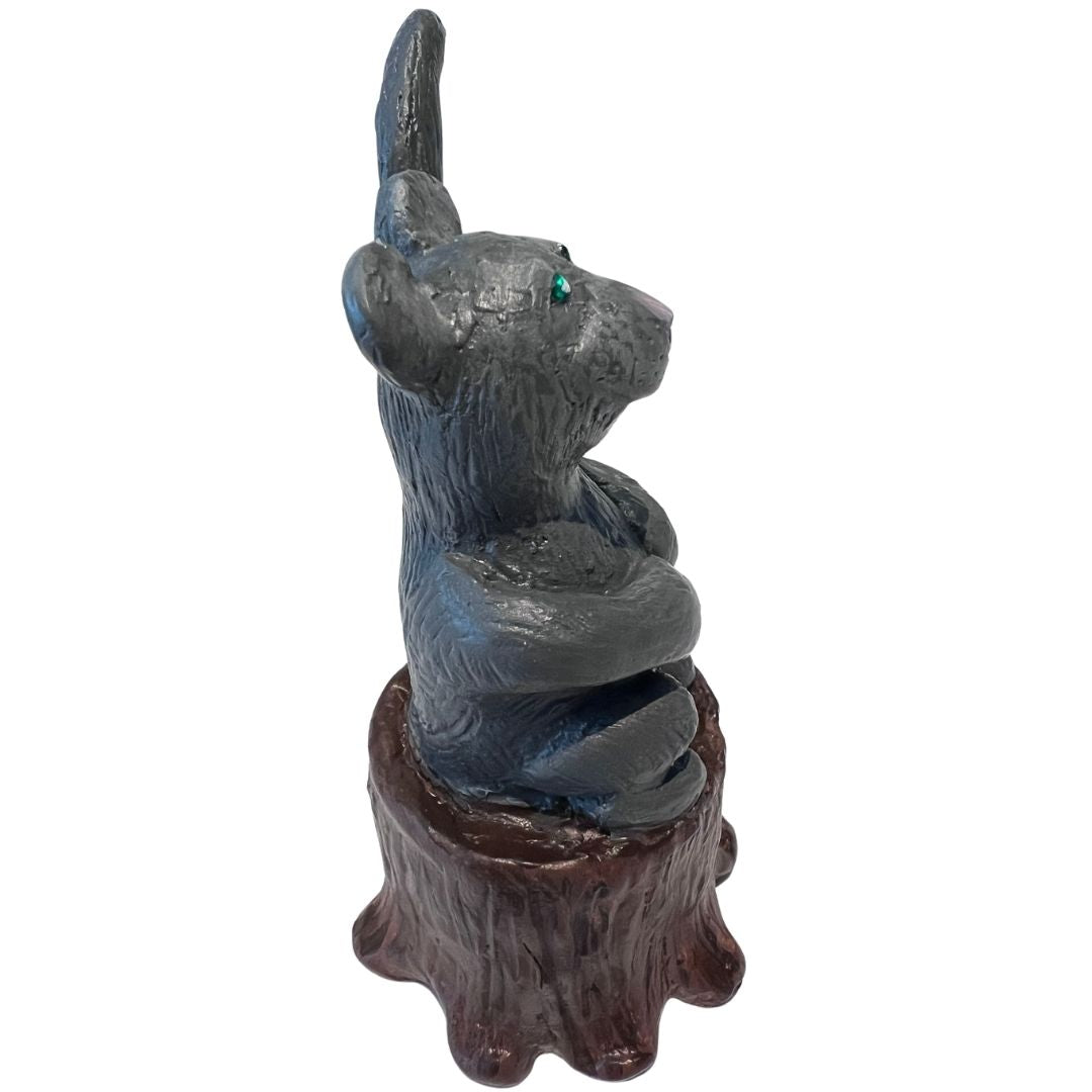 profile view of gray mouse ring holder sculpture on a wood stump base hand sculpted from polymer clay