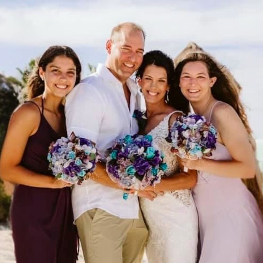 Purple and turquoise seashell bridal bouquet with coastal flowers, designed for beach weddings and destination brides by Daree’s Designs