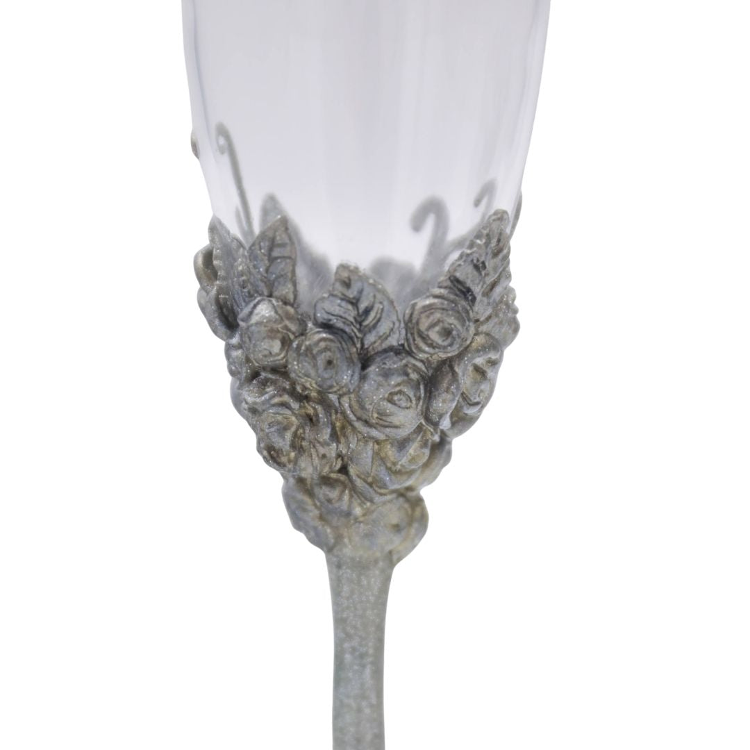 Close view of hand sculpted silver roses and metallic floral detailing on Victorian champagne flute
