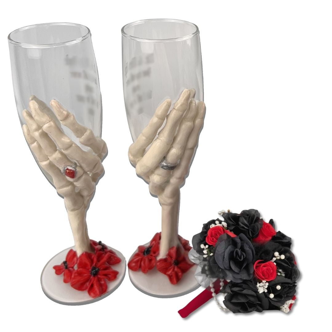 Hand sculpted skeleton hand champagne glasses with red floral base shown with black and red gothic wedding bouquet