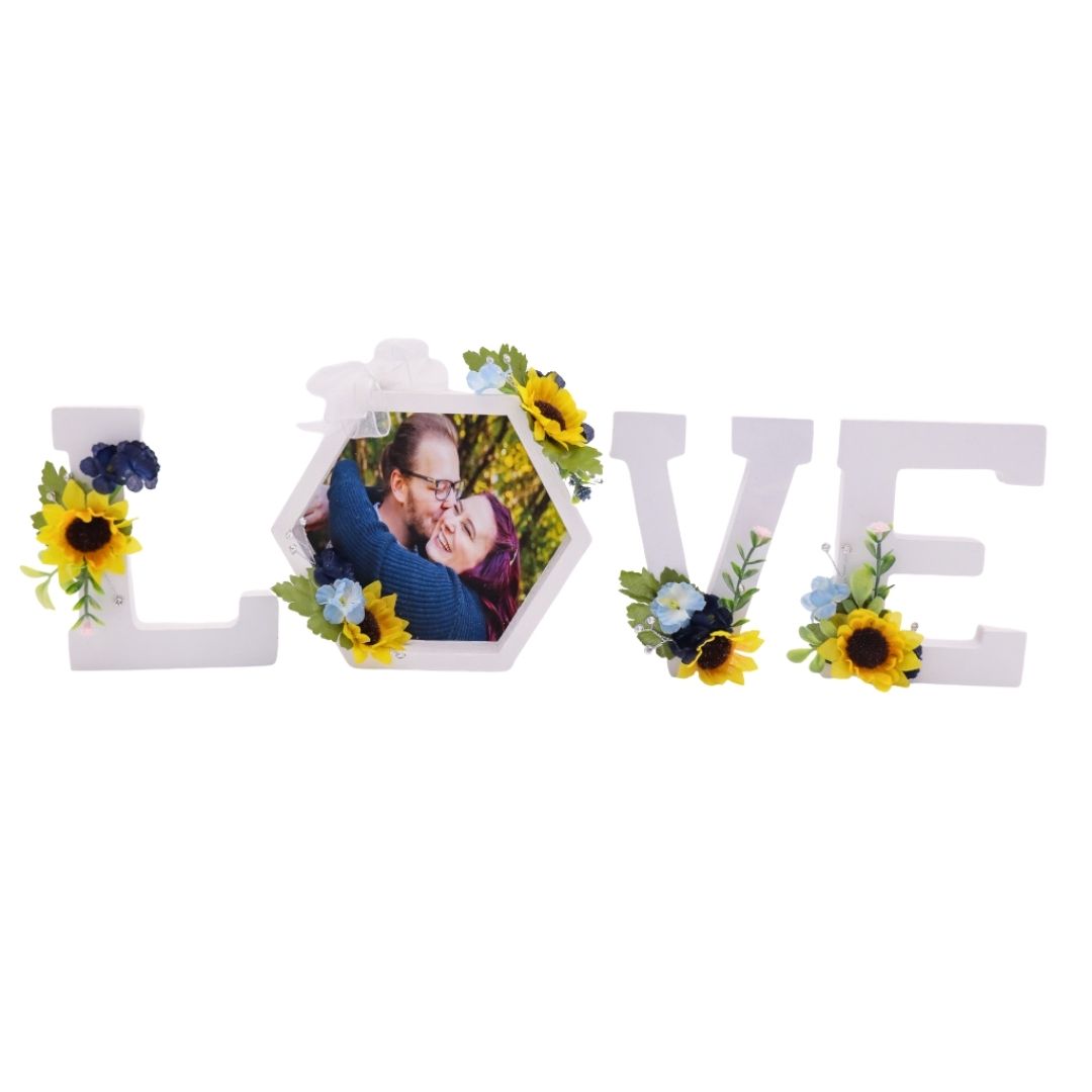 Sunflower LOVE photo frame centerpiece with blue and yellow flowers and hexagon picture frame on white background