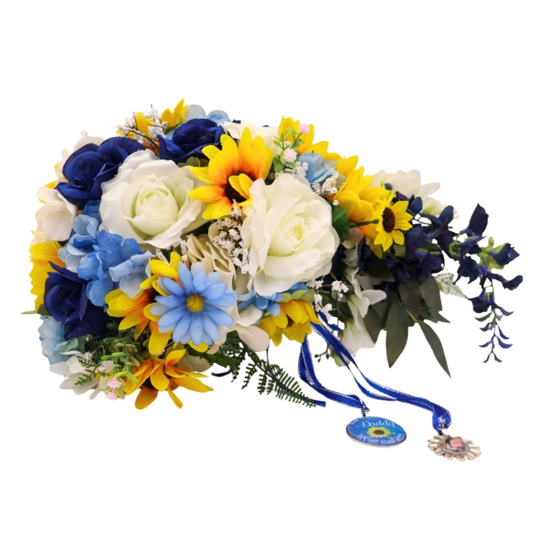 Extra large cascading bridal bouquet with sunflowers, sapphire blue roses, ivory roses, and blue hydrangea in a teardrop shape with trailing greenery and optional memorial photo charm

