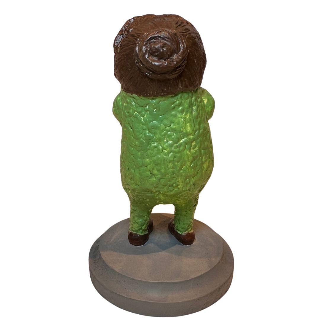 Back view of Tea & Biscuits showing sculpted brown hair, textured green skin and weathered-gray base.