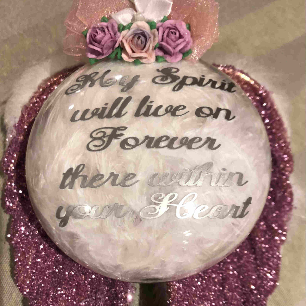 These acrylic ornaments are made in a variety of colors with custom verses, and adorned with glitter, feathers, fur, charms, flowers, or other decorative elements dependent on your selection.