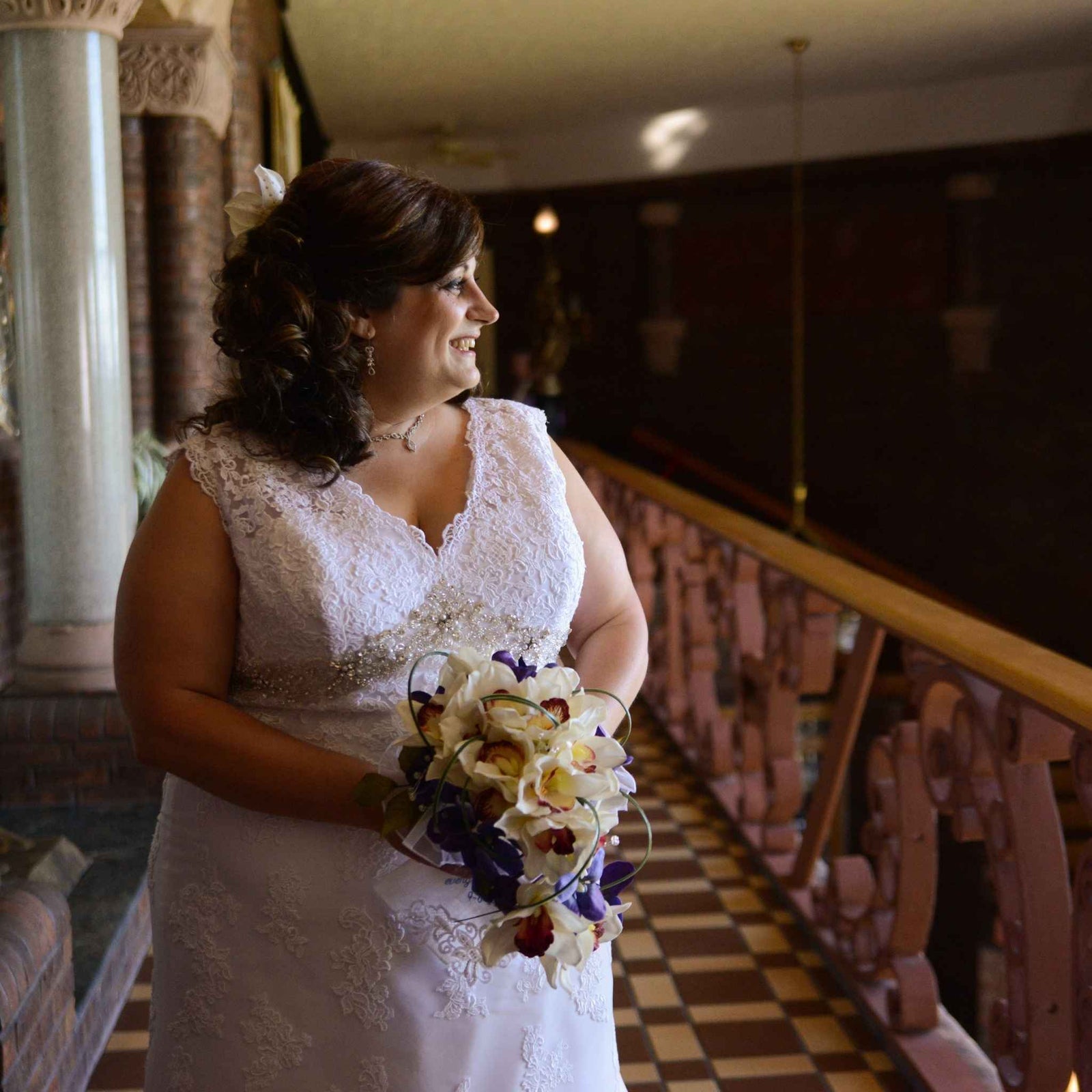 Created with silk orchids and various accent tropical flowers, greenery and clear sparkle stems, the bouquet sits atop a handle wrapped in satin to be both beautiful and comfortable.