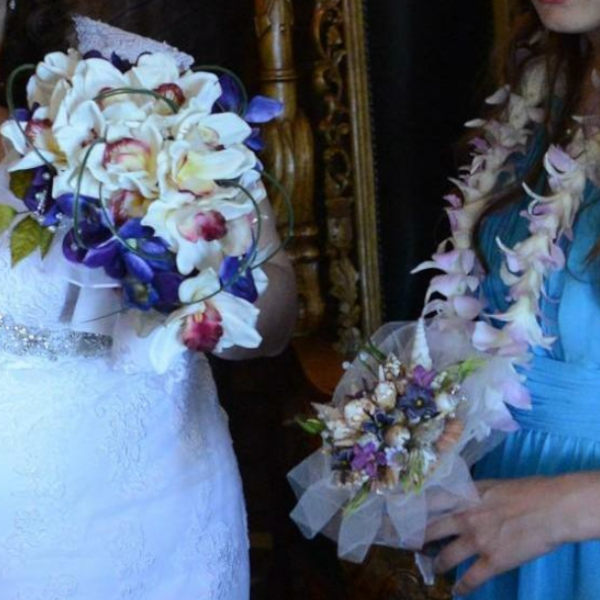 Bring the beach to your summer or tropical wedding ceremony set in greenery and adorned with cone shells and small silk flowers.
