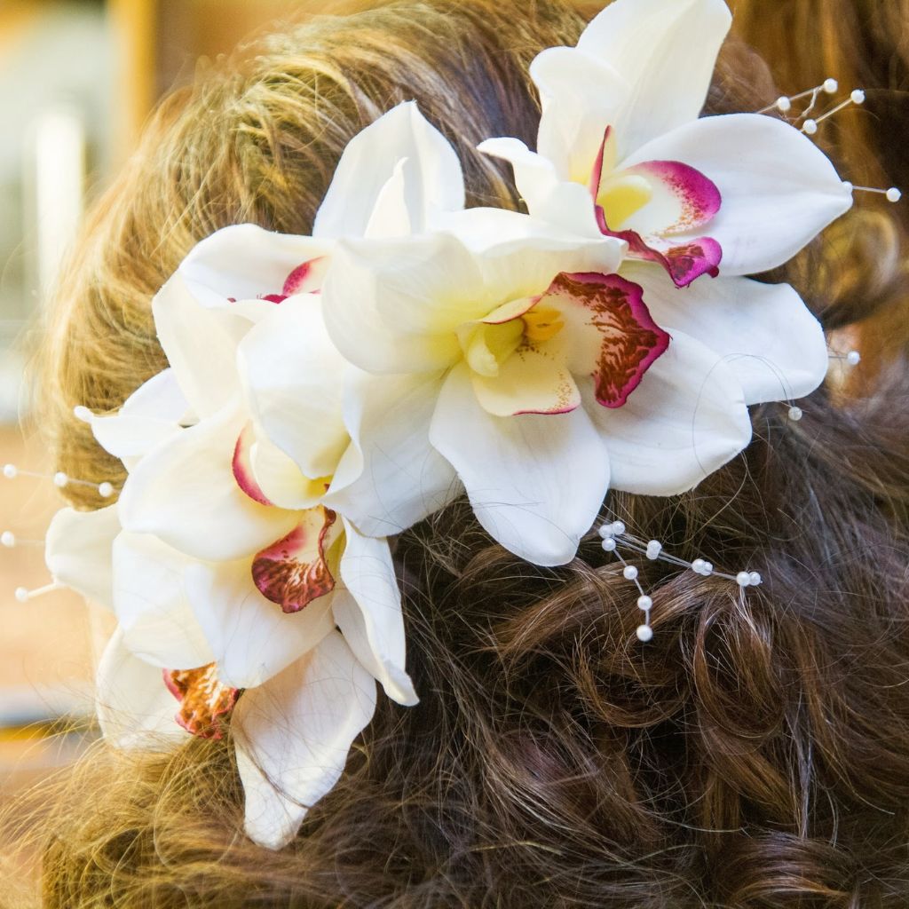 orchid in hair #bridalhair #accessories #weddinghair | Hairdo wedding,  Flowers in hair, Wedding hair and makeup