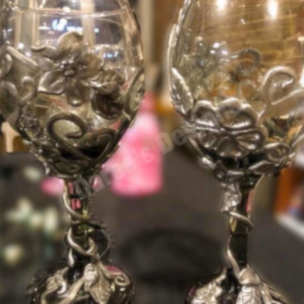 Each wine glass sits atop a hand-scuplted polymer clay painted stem of metallic leaves and vines.