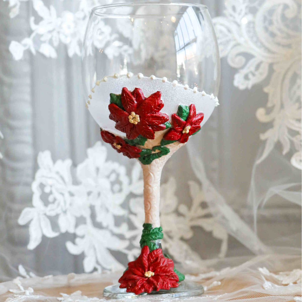 Perfect for any Christmas themed wedding or event, our Poinsettia Wine Glasses are perfect for yourself or as a gift.  Each wine glass sits atop a hand-scuplted polymer clay painted stem of red poinsettias, complimented with soft shimmery magical glitter.