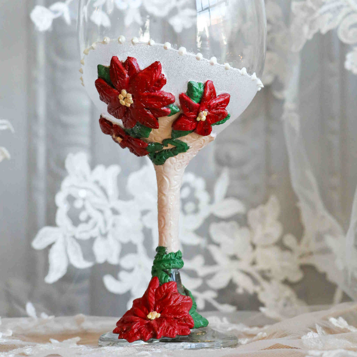 Perfect for any Christmas themed wedding or event, our Poinsettia Wine Glasses are perfect for yourself or as a gift.  Each wine glass sits atop a hand-scuplted polymer clay painted stem of red poinsettias, complimented with soft shimmery magical glitter.