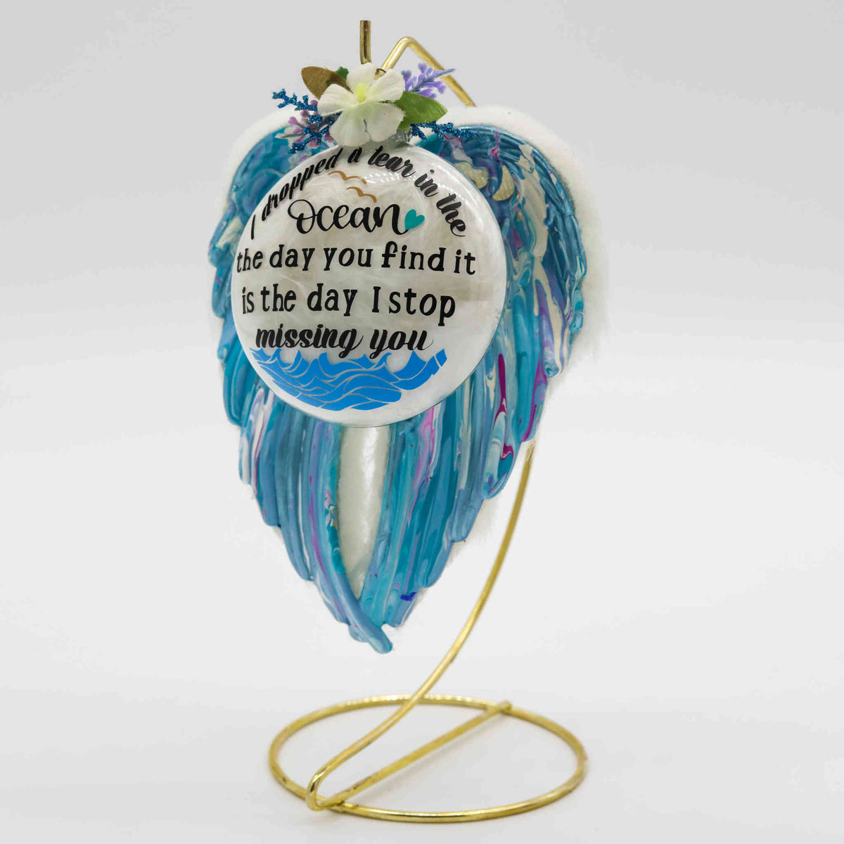 These poured acrylic ornaments are made in a variety of colors with custom verses, and adorned with feathers, fur, charms, flowers, or other decorative elements dependent on your selection.