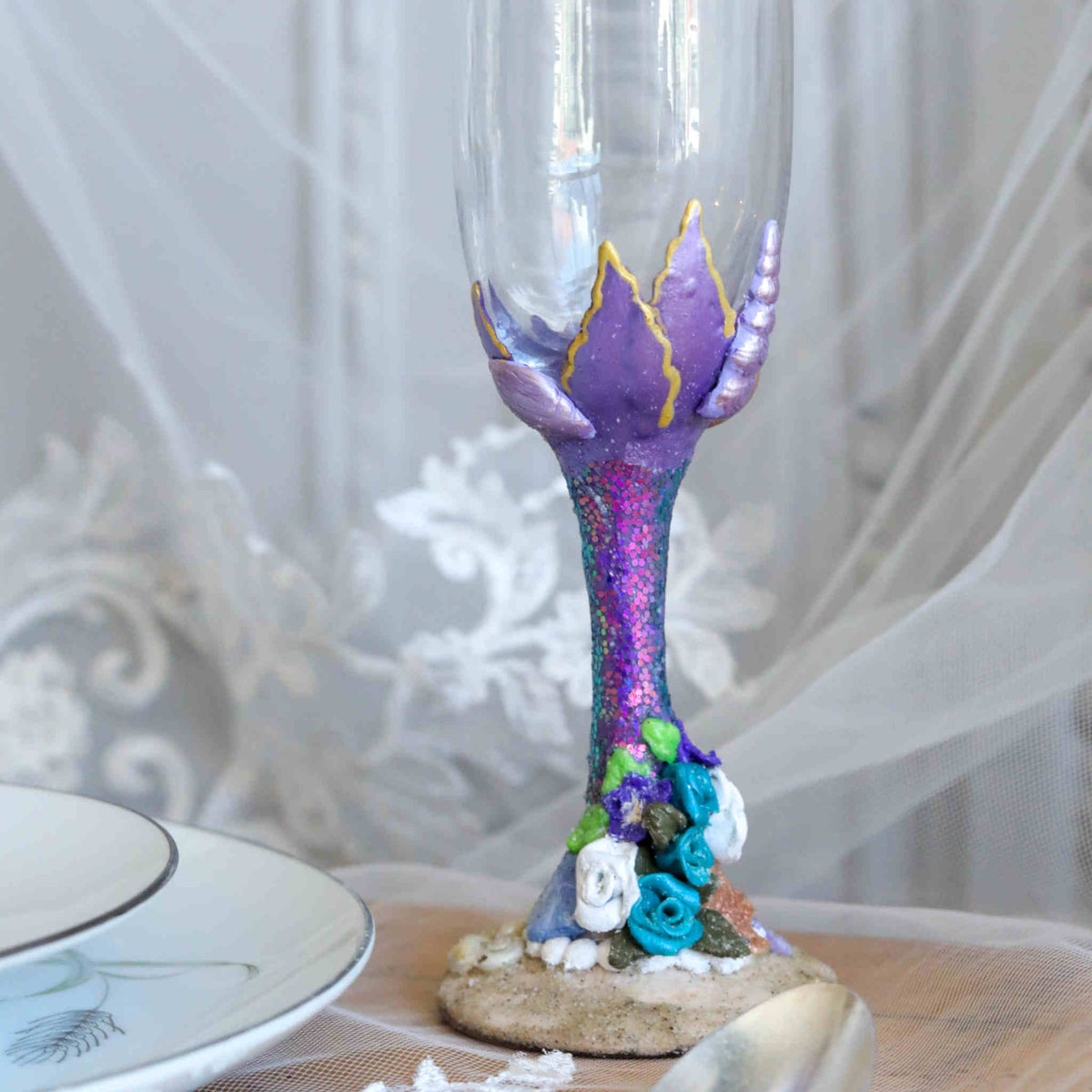 Enjoy the sea and sand while you toast to each other on your special wedding day or wedding anniversary. Each flute is hand-scuplted and painted with purple, teal, and white tiny seashells and flowers using polymer clay and sealed to last.