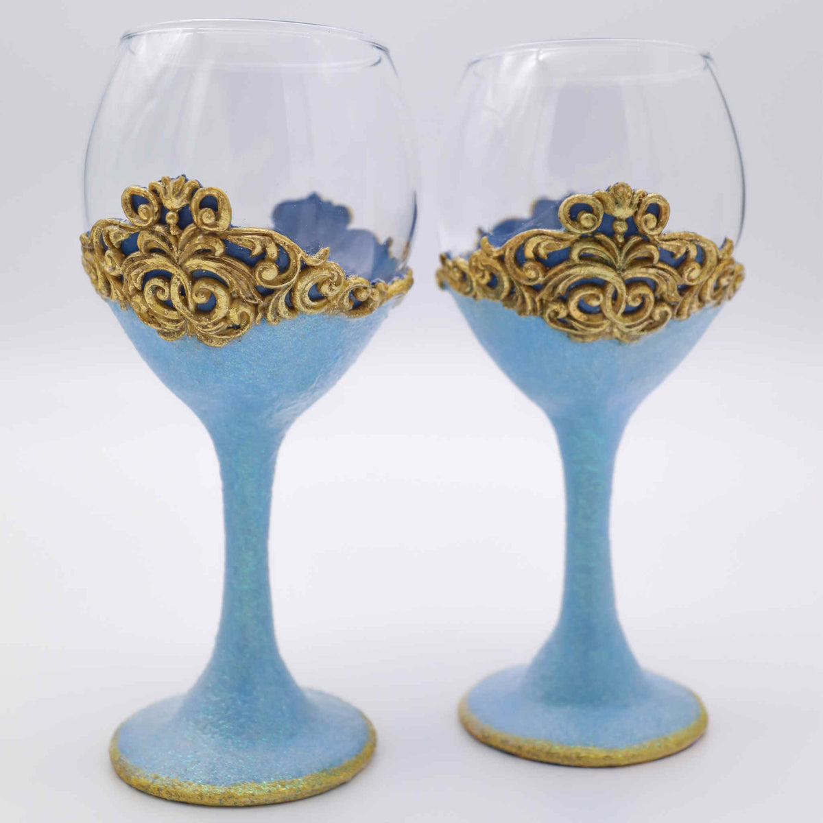 Add a touch of fairytale splendor and enchanted romance with our steamware set. It is the perfect way to add a little sparkle and a special touch of color. Makes a wonderful gift for engagements, showers, weddings and anniversaries. Each wine glass is hand-scuplted with polymer clay blue base and stem that shimmers with a touch of glitter. A gold leaf accents the bottom edge and &quot;lace&quot; top.