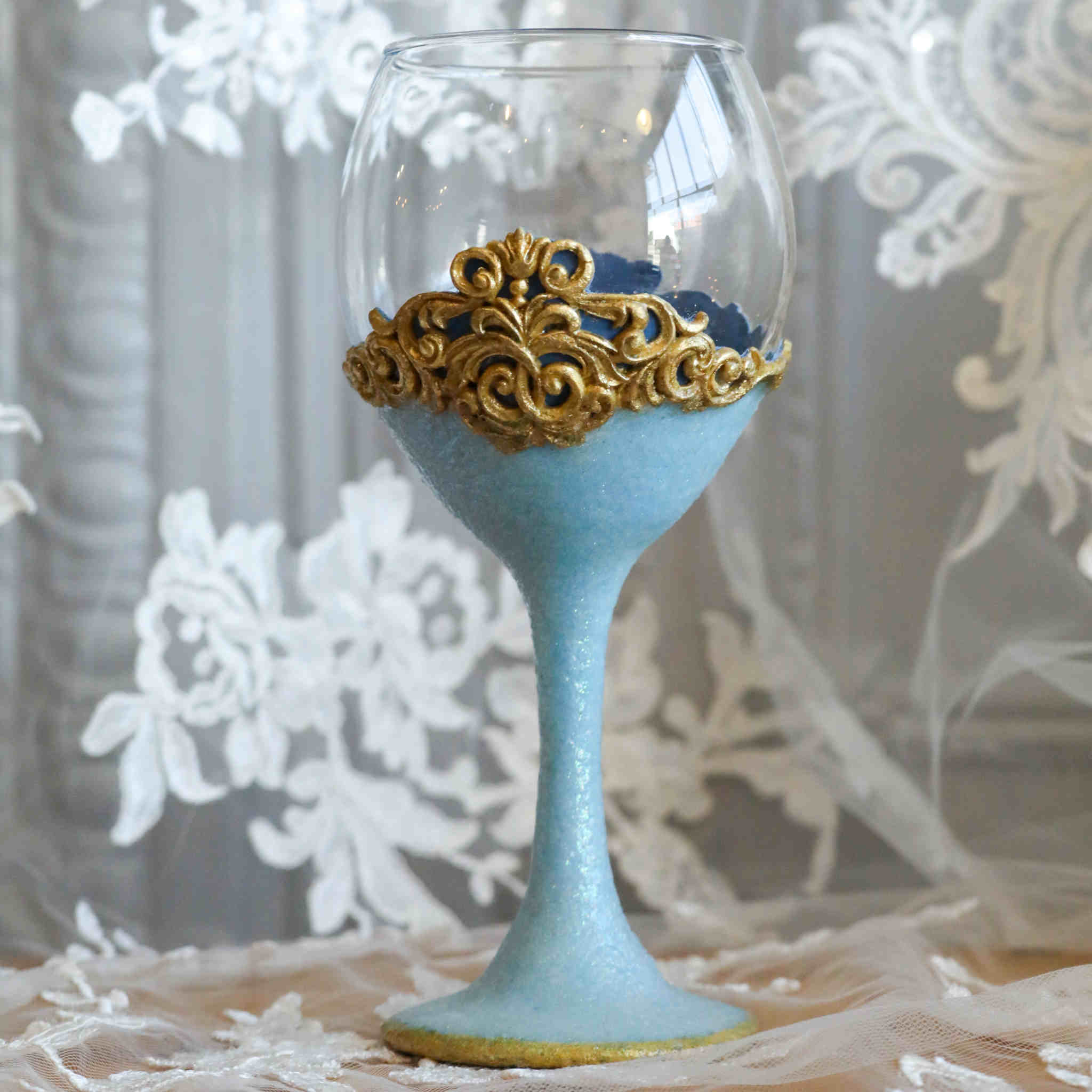 https://dareesdesigns.com/cdn/shop/products/shimmering-blue-and-gold-wine-glass-set-lifestyle-1_2048x.jpg?v=1665289856