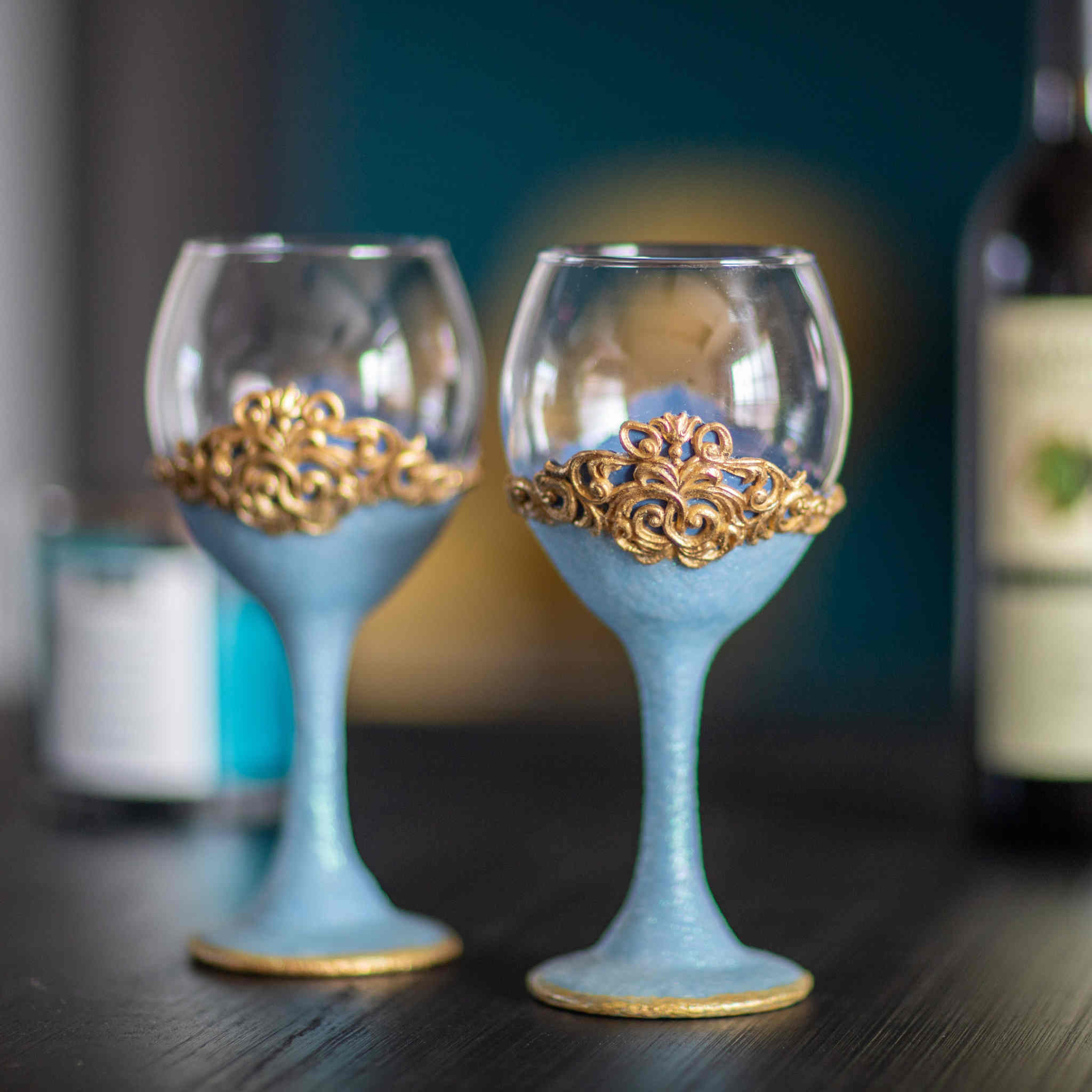https://dareesdesigns.com/cdn/shop/products/shimmering-blue-and-gold-wine-glass-set-lifestyle-3_2048x.jpg?v=1665289856