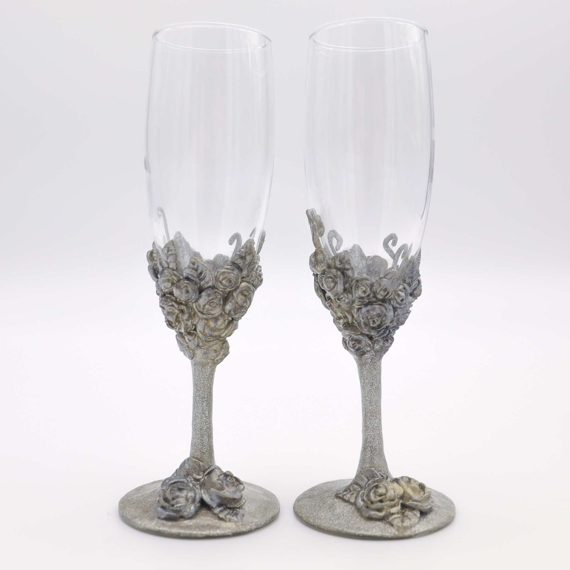 Celebrate your love with our stemware gift set. Each steamware set is the perfect way to add a little sparkle and a special touch of color. Makes a wonderful gift for engagements, showers, weddings and anniversaries. Each wine glass is hand-scuplted with polymer clay base and stem of metallic roses, leaves, and vines.