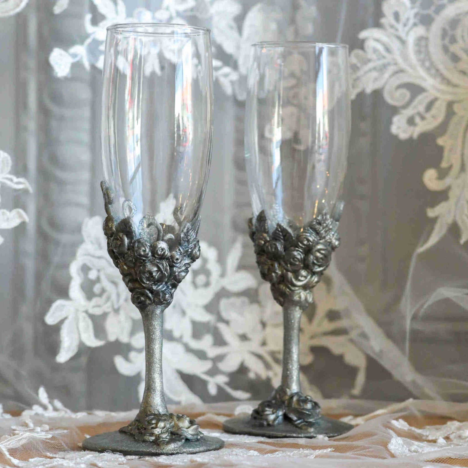 Celebrate your love with our stemware gift set. Each steamware set is the perfect way to add a little sparkle and a special touch of color. Makes a wonderful gift for engagements, showers, weddings and anniversaries. Each wine glass is hand-scuplted with polymer clay base and stem of metallic roses, leaves, and vines.