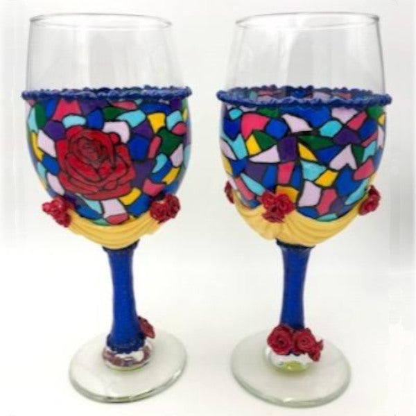 Bring a piece of an enchanted rose to your wedding day or anniversary celebration. This set will have you dreaming of your happily ever after. Each multicolored mosaic glass is hand-painted with red rose centered on the bowl. With clusters of sculpted red roses and yellow swag. Stem is blue sculpted and finished off with professional grade glitter for a pop of sparkle.