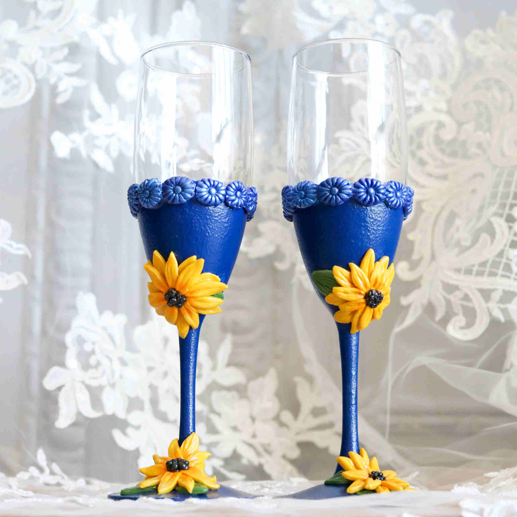 https://dareesdesigns.com/cdn/shop/products/sunflower-and-sapphire-champagne-toasting-flutes-lifestyle-1_2048x.jpg?v=1666806596