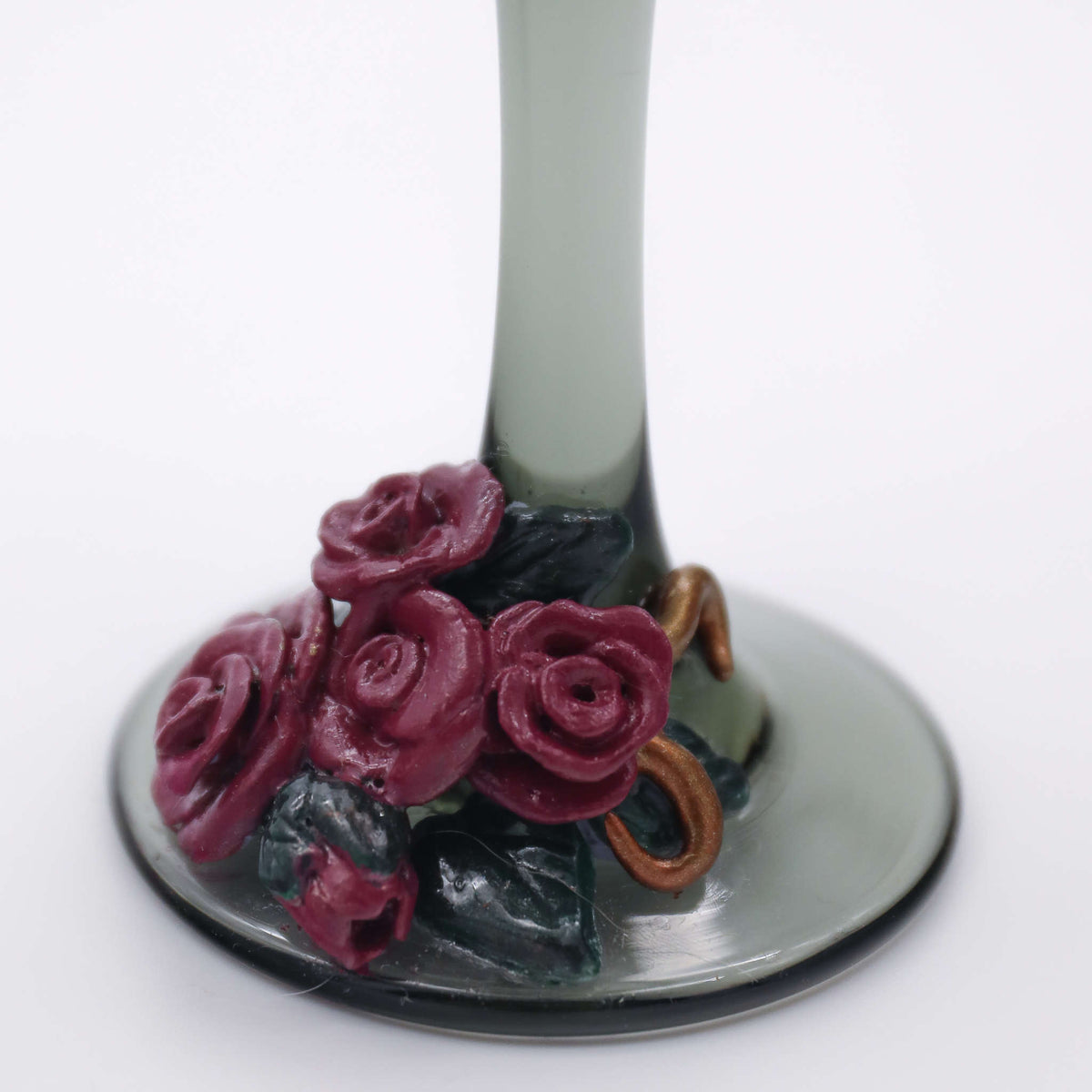 Bring the classic Victorian era to your wedding day or anniversary celebration. Each black-tinted glass is hand-scuplted with burgundy roses laid within a metal-inspired polymer and clay pattern.